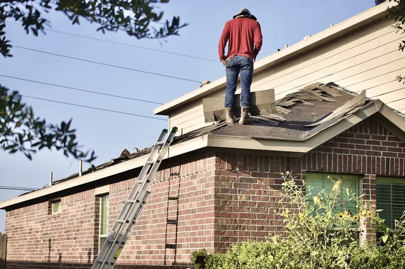 Professional roofer working on a residential roof in Long Crossing